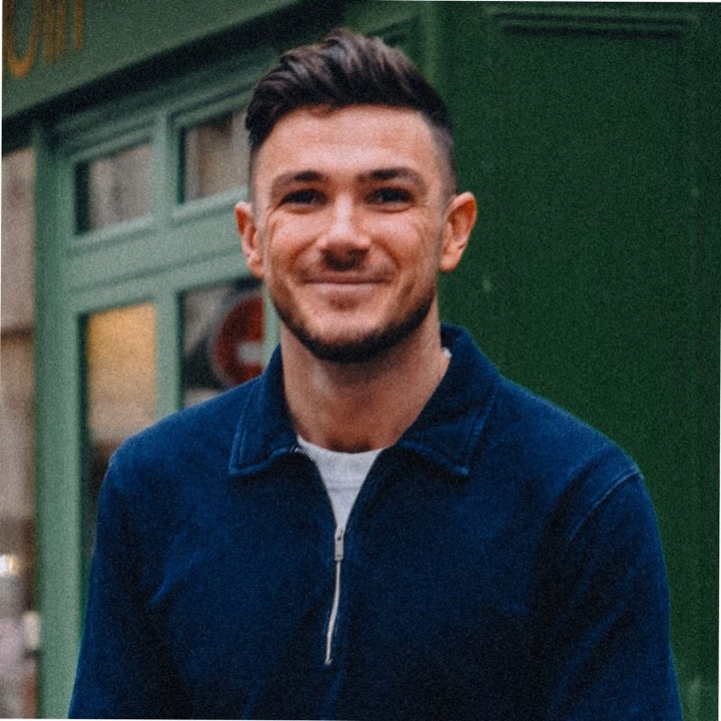 Man smiling for portrait in blue jumper