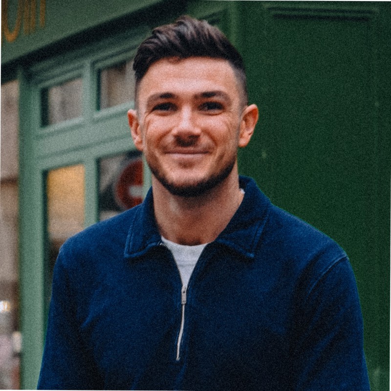 Man smiling for portrait in blue jumper